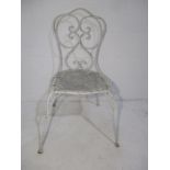 A single wrought iron garden chair with scroll work detailing