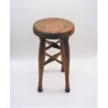 A vintage wooden stool, with cross stretchers.