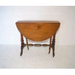 A Victorian mahogany Sutherland table, on turned legs with carved detailing.