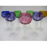 A set of seven cut glass multi coloured hock glasses