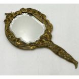 A small handheld gilt mirror with harlequin, moon and cat motifs