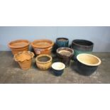 A quantity of various garden pots, including some terracotta, some glazed.