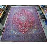 A large red ground Iranian carpet, approximately 387cm x 292cm.