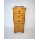 A tall pine chest of five drawers, length 49cm, height 118cm, depth 43cm.