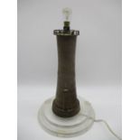 A wooden lamp in the form of a lighthouse on tiered perspex base