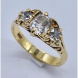 An 18ct gold diamond three stone ring set with old cut diamonds, the central stone of approx. 0.