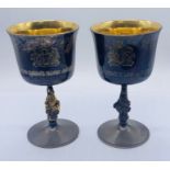 A pair of silver and parcel gilt goblets with Queens Beast stems by Garrard & Co, in celebration