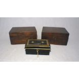 A metal lockbox, with key, along with two other wooden boxes.