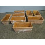 A set of eight matching terracotta planters. 16cm x 32cm, height 14cm