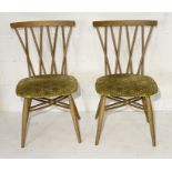 A pair of Ercol candlestick chairs with cross over backs - in need of some restoration