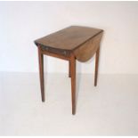 A Georgian mahogany drop leaf table, with single drawer, on tapering legs.