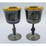A pair of silver and parcel gilt goblets with Queens Beasts stems by Garrard & Co, in celebration of