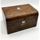 A mahogany dressing box with secret drawer, inlaid mother of pearl containing a number of silver