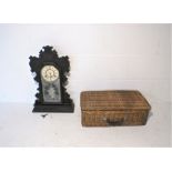 An Ansonia wooden mantle clock, along with a wicker picnic hamper.