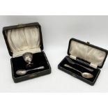 A cased hallmarked silver Christening set consisting of egg cup and spoon along with one other