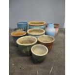 A collection of ten glazed garden pots.