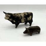 A studio pottery cow along with a smaller pottery pig