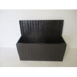 A plastic garden storage box, length 116cm.