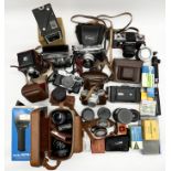 A collection of various vintage cameras, lenses and equipment including Prakitca VLC 2, Yashica