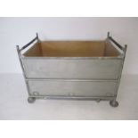 An industrial metal framed bobbin trolley from Axminster Carpets