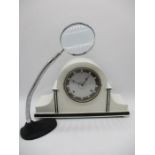 A white painted Westminster chime mantle clock along with an adjustable magnifying glass on stand