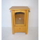 An oak shaker style cabinet, marked 'Sherry', with glazed single door and single drawer below,