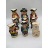A collection of nine ceramic toby jugs including a lamp and a musical one