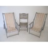Two painted deck chairs plus a weathered wooden garden chair.