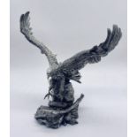 A hallmarked silver (filled) model of an eagle on tree stump