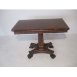 A Victorian rosewood card table on claw feet.