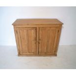 A pine cupboard, with two doors, length 108cm, height 91.5cm.