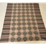A welsh wool blanket of traditional reversible geometric design in pink black and cream - no