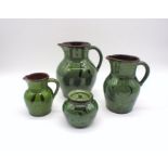 A collection of studio pottery marked 'NH, Axminster', comprising of three green glazed jugs and a