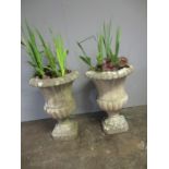 A pair of reconstituted stone garden urns, height 66cm.