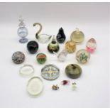 A collection of glass paperweights, along with a tilt marble paperweight, a glass scent bottle and