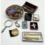 A collection of costume jewellery along with a silver handled magnifying glass etc.