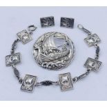 A Scandinavian style hallmarked silver brooch, bracelet and earrings, all depicting a longship