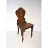 A Victorian oak shield back hall chair.