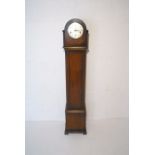 An oak cased grandmother clock, with carved decoration, the dial marked 'Enfield', height 140cm.