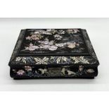 A modern Chinese black lacquer games box with inlaid mother of pearl floral and bird motifs
