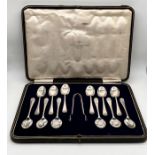 A cased set of hallmarked silver 12 coffee spoons and sugar nips