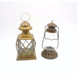 A brass lantern along with another similar.