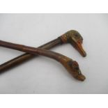 Two "swagger" style sticks with animal head finials