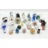 A large collection of glass paperweights including Murano style