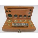 A cased set of Chemist scale weights with tweezers