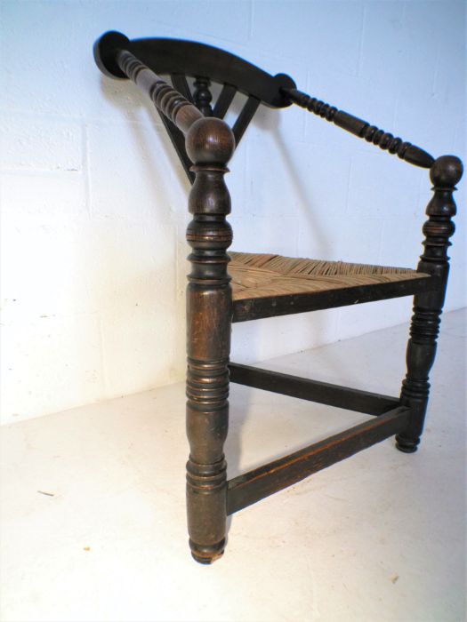 A Liberty style oak corner chair with rush seat. - Image 5 of 5