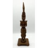 A wooden carving of a praying Thai Buddha - height 66cm