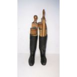A pair of men's riding boots with boot trees.