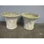 A pair of large, reconstituted stone planters. Diameter at widest point 56cm.