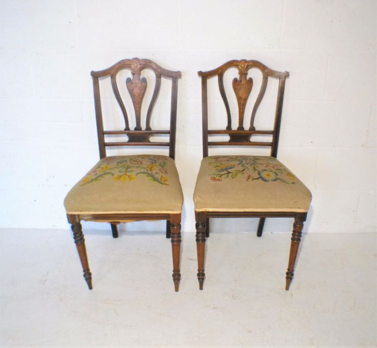 A pair of Edwardian inlaid mahogany chairs, with tapestry seats.